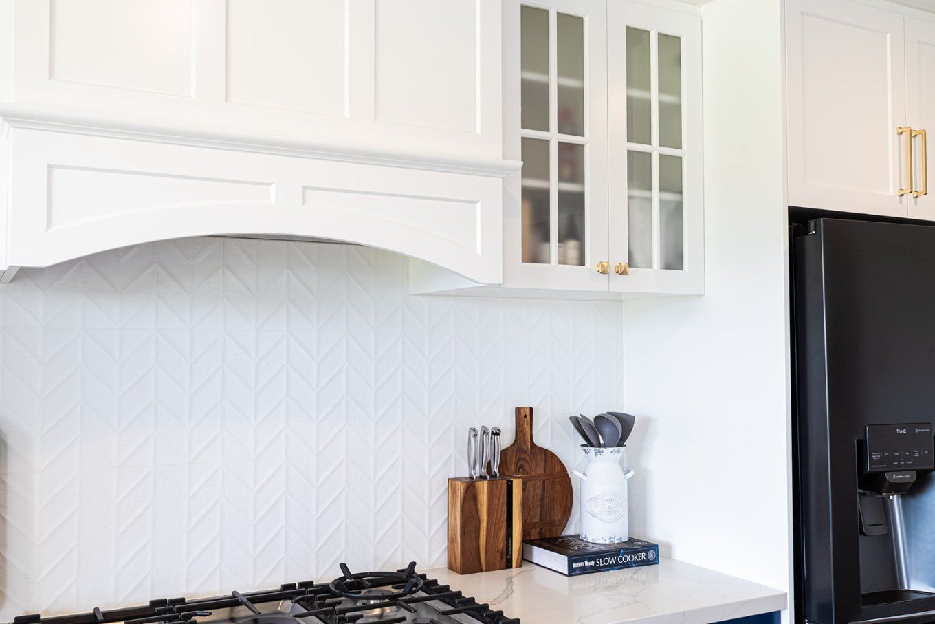 White Kitchen Corner With Stove, Wooden Cutting Boards, and White Cabinets With Frosted Glass — Truline Cabinets In Tuchekoi, QLD