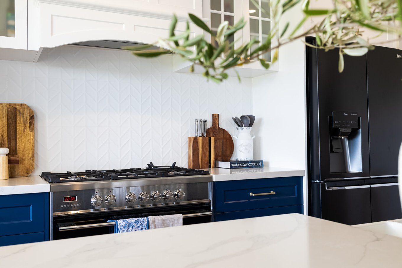 Kitchen Interior Featuring a Blue and White Color Scheme, a Large Stainless Steel Oven, and a Black Refrigerator — Truline Cabinets In Tuchekoi, QLD