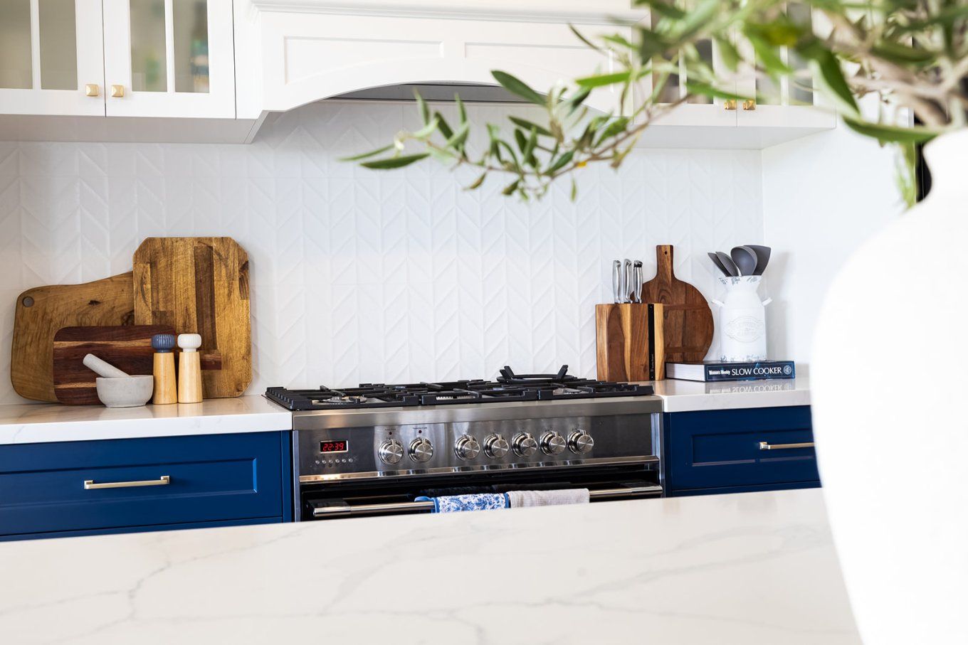 Kitchen With Blue Cabinets, White Backsplash, and a Stainless Steel Stove — Truline Cabinets In Tuchekoi, QLD