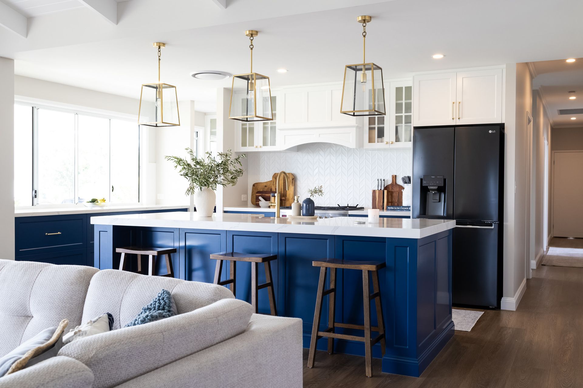 A Blue Kitchen Island With A Stone Top and Bar Stools — Truline Cabinets In Tuchekoi, QLD