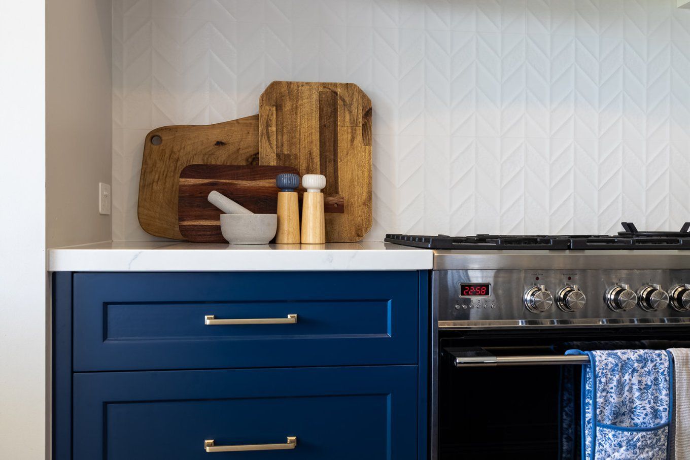 Blue Kitchen Cabinets and Stainless Steel Oven, With Cutting Boards and Seasonings on the Countertop — Truline Cabinets In Tuchekoi, QLD