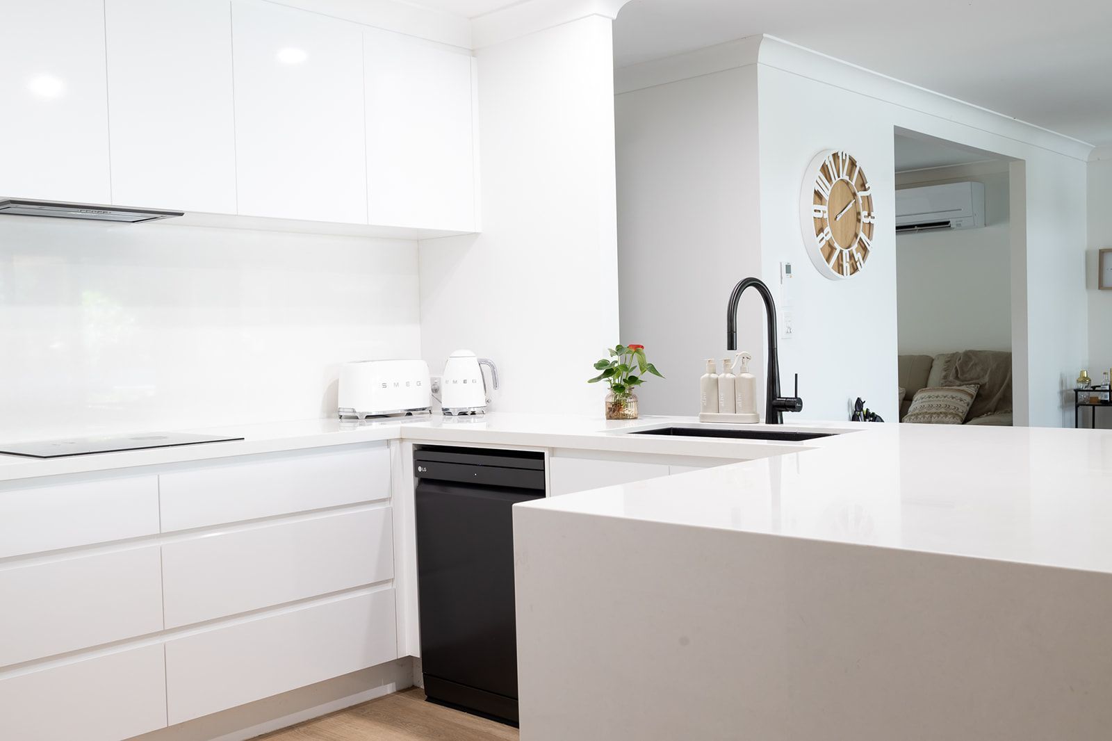 Modern White Kitchen With Black Appliances and Faucet — Truline Cabinets In Tuchekoi, QLD