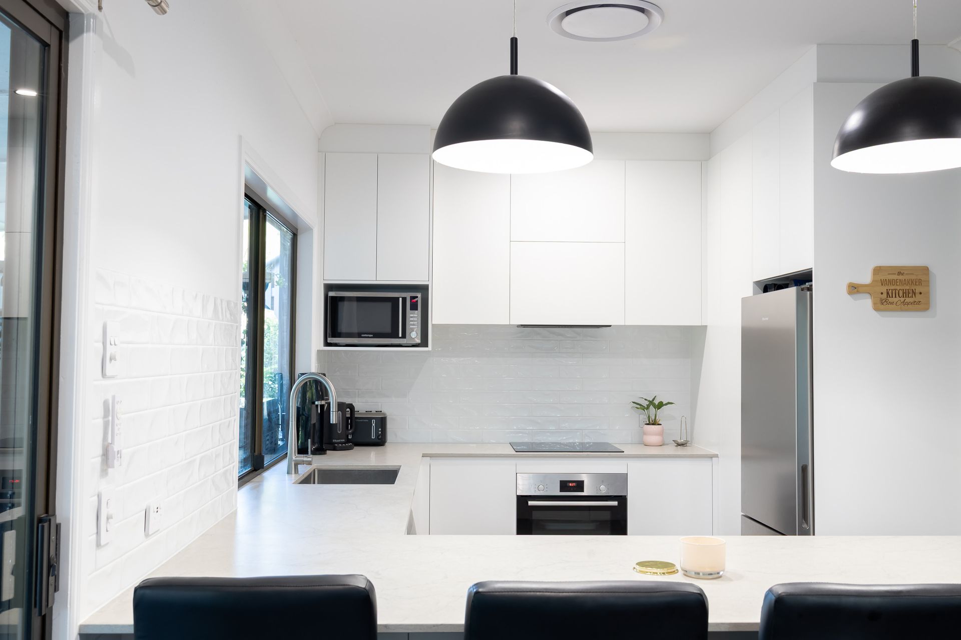 A Large Drop Light Over A White Kitchen — Truline Cabinets In Tuchekoi, QLD