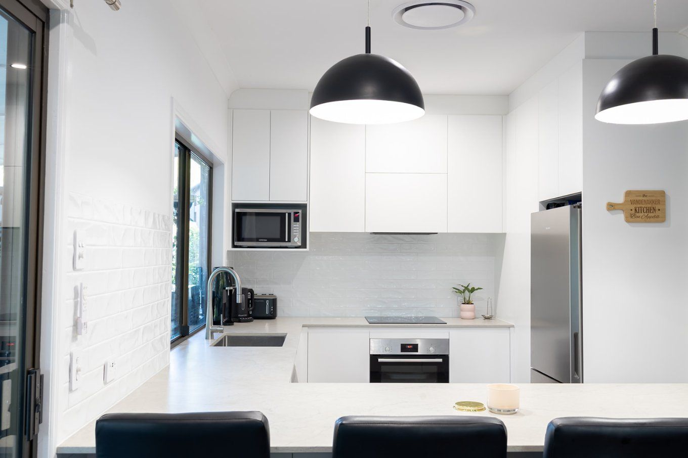 Bright White Modern Kitchen With Stainless Steel Appliances, and a Breakfast Bar — Truline Cabinets In Tuchekoi, QLD