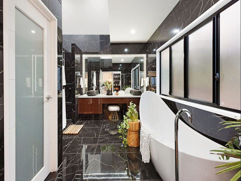 Luxurious Modern Bathroom With a Freestanding Tub, Dark Marble Tiles, and a Double Vanity — Truline Cabinets In Tuchekoi, QLD
