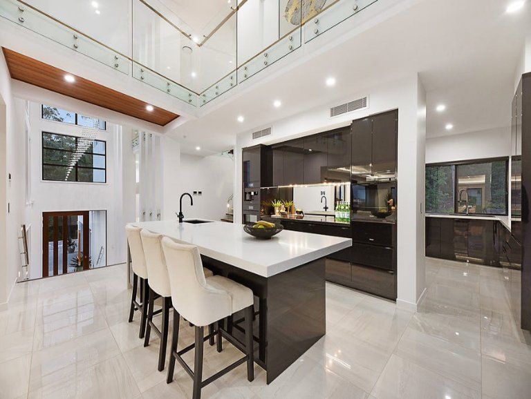 Modern Kitchen With White Marble Floors, Large Island With Bar Stools, and Dark Cabinets — Truline Cabinets In Tuchekoi, QLD