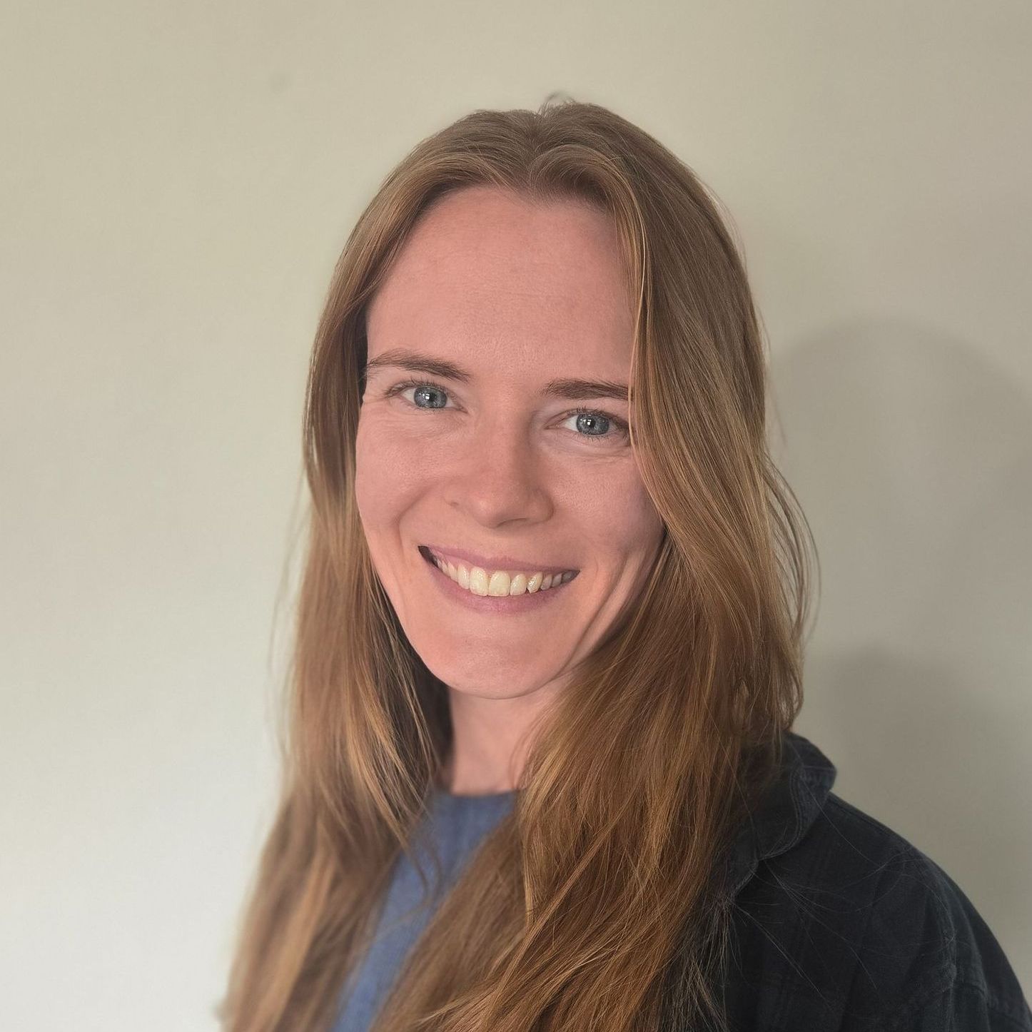 A close up of a woman 's face smiling in a car.