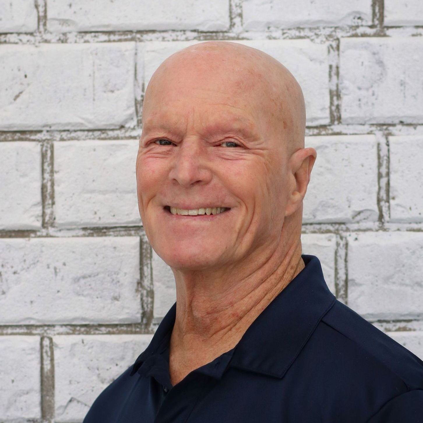 A man is sitting at a desk with a pen in his hand.