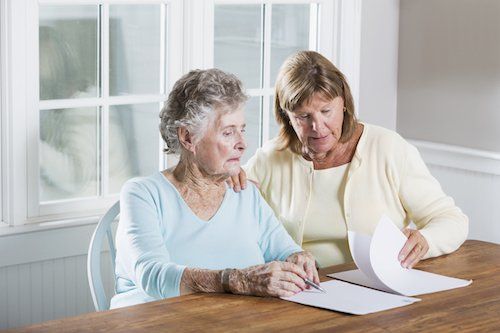 two older women look at papers