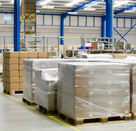 A large warehouse filled with lots of boxes and pallets