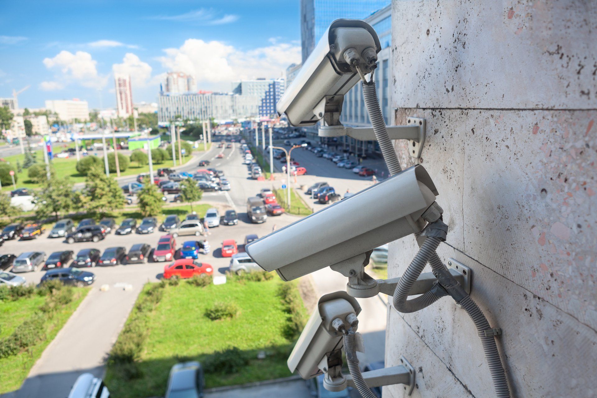 A row of security cameras mounted on the side of a building.