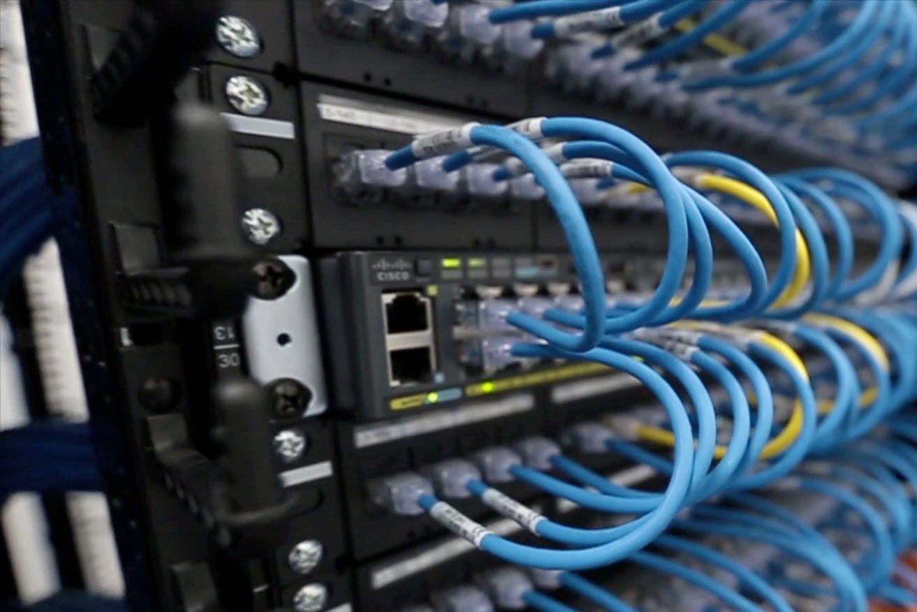 A bunch of blue wires are connected to a server