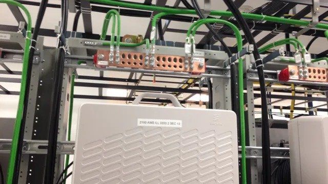 A white box with a handle is sitting in a server room