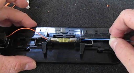 A person is holding a piece of electronic equipment in their hands.