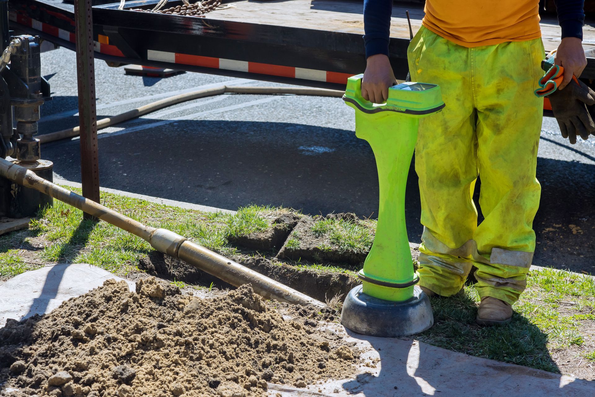 A man in yellow pants is standing next to a yellow object.