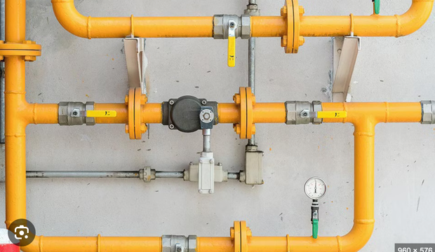 HVAC system installation: gas boiler, copper piping, radiant heating manifold, and ductwork in a utility room.