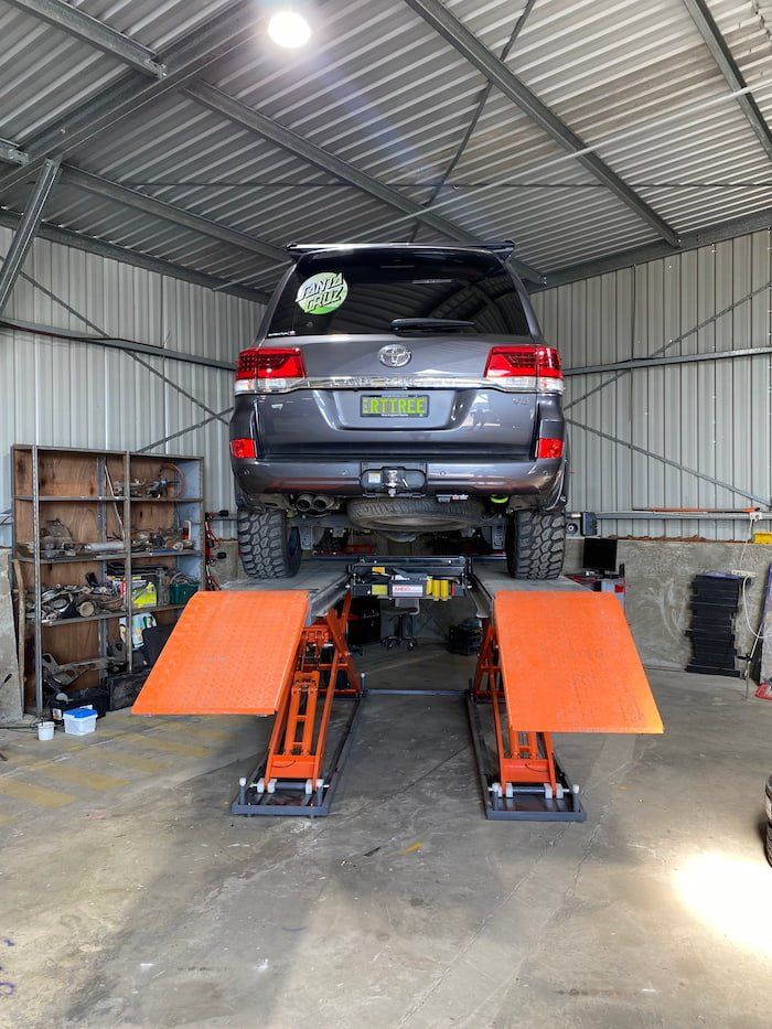 Vehicle on Lift at Mechanics — Wheel and Tyre Services in Inverell, NSW