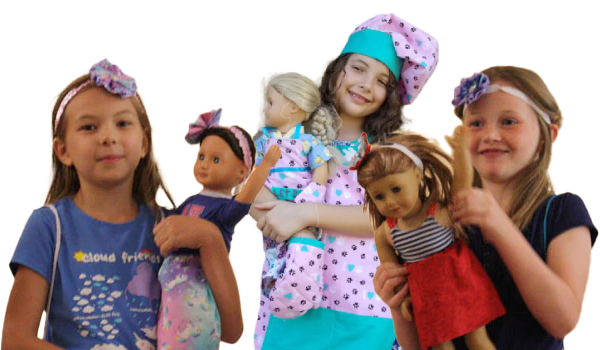 Three little girls are holding dolls and one of them is wearing a chef hat