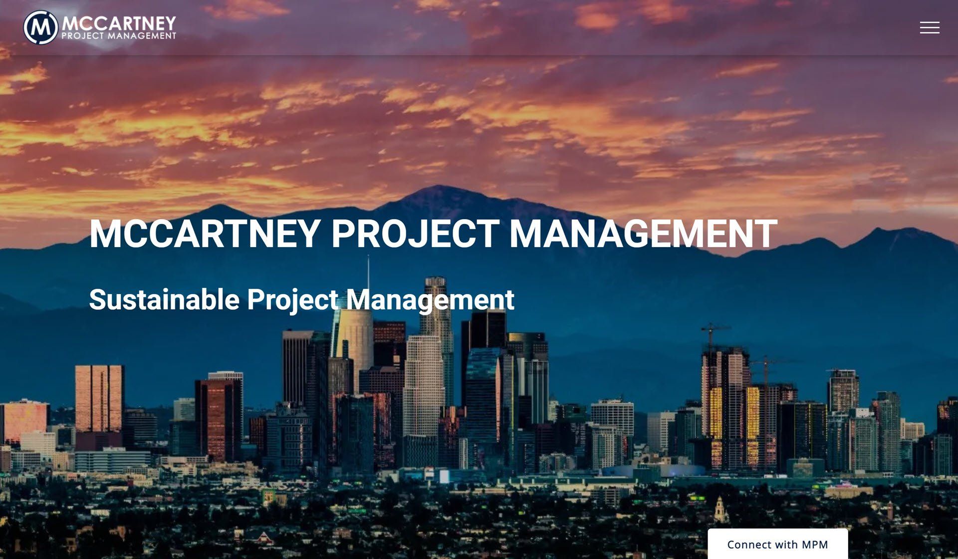 A website for mccartney project management shows a city skyline with mountains in the background.