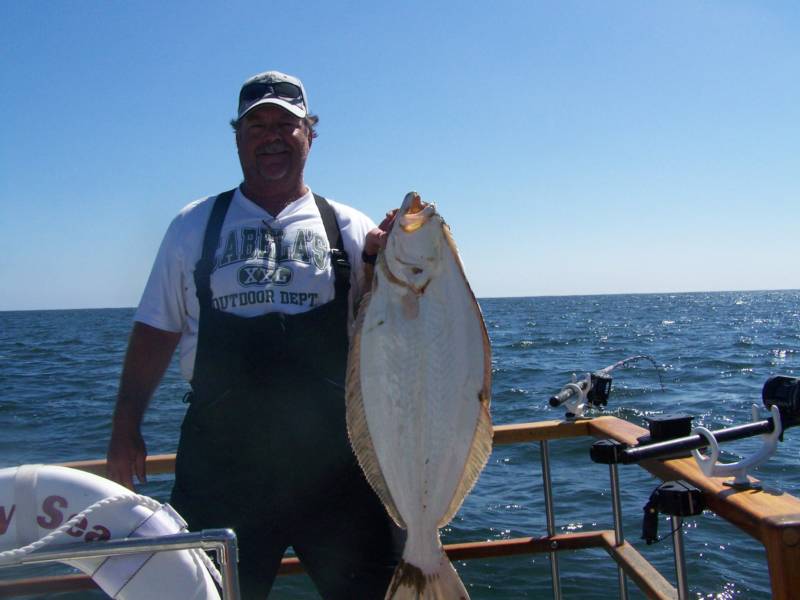 A man on a boat with a shirt that says apples on it