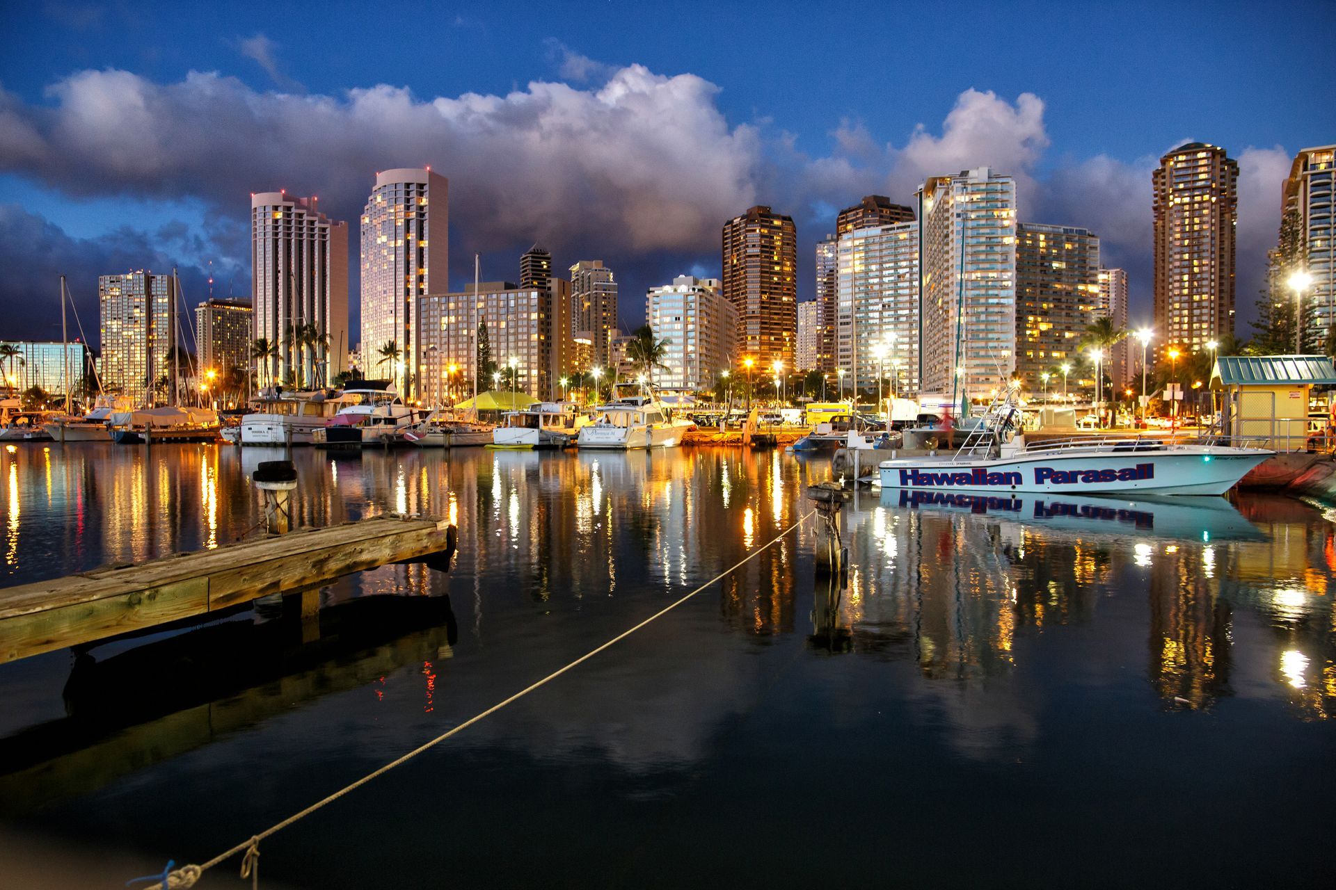 A city skyline is reflected in a body of water