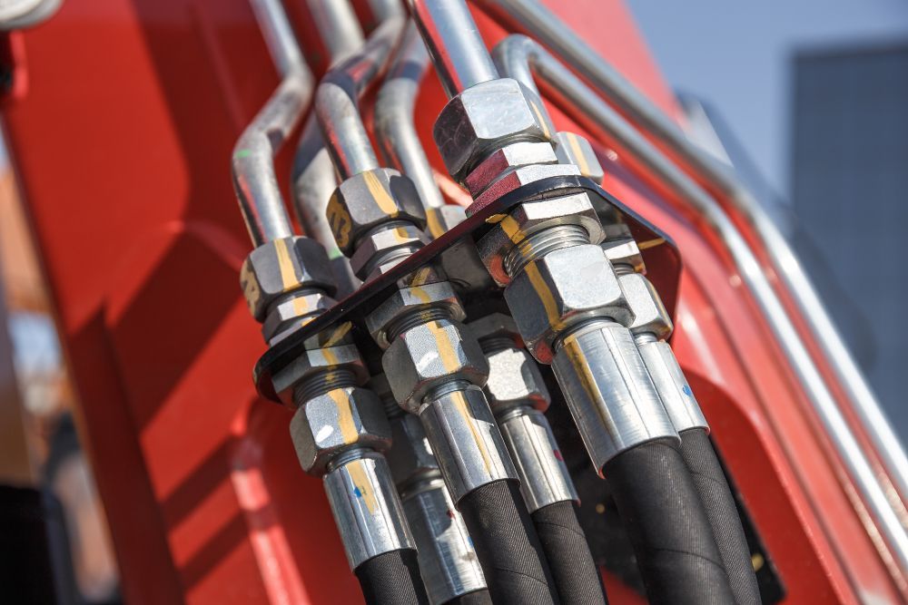 A Close Up of Hydraulic Hoses Attached to a Machine — Hydrofit Service in Shellharbour, NSW
