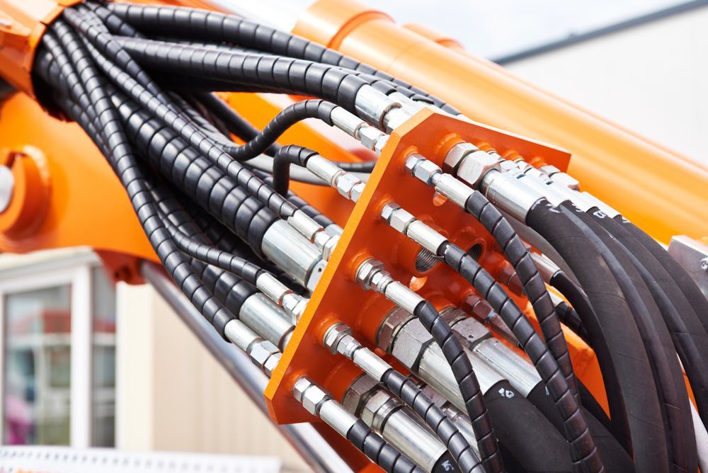 A Bunch of Hydraulic Hoses Are Attached to a Machine — Hydrofit Service in Wollongong, NSW
