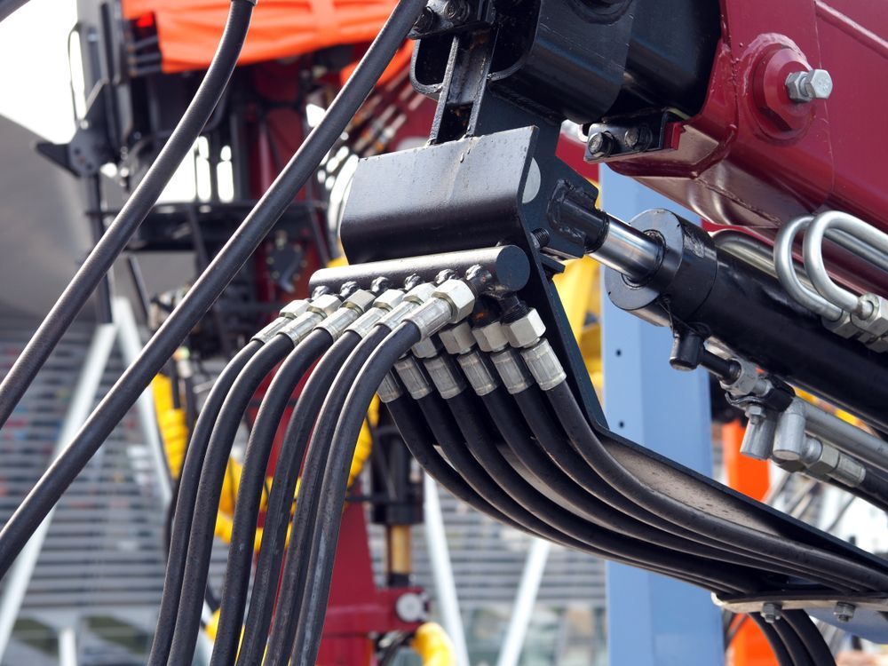 A Bunch of Hydraulic Hoses Are Connected to a Machine — Hydrofit Service in Wollongong, NSW