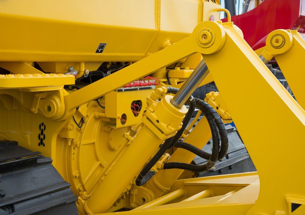 A Close Up of a Yellow Hydraulic System on a Machine — Hydrofit Service in Campbelltown, NSW