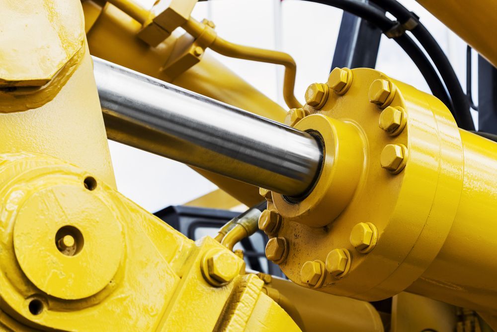 A Close Up of a Yellow Hydraulic Cylinder on a Bulldozer — Hydrofit Service in Wollongong, NSW