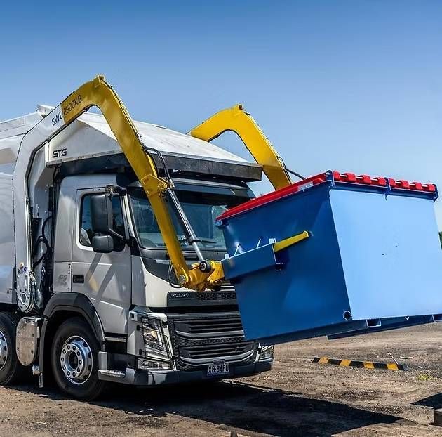 A Garbage Truck With a Blue Dumpster Attached to It — Hydrofit Service in Wollongong, NSW