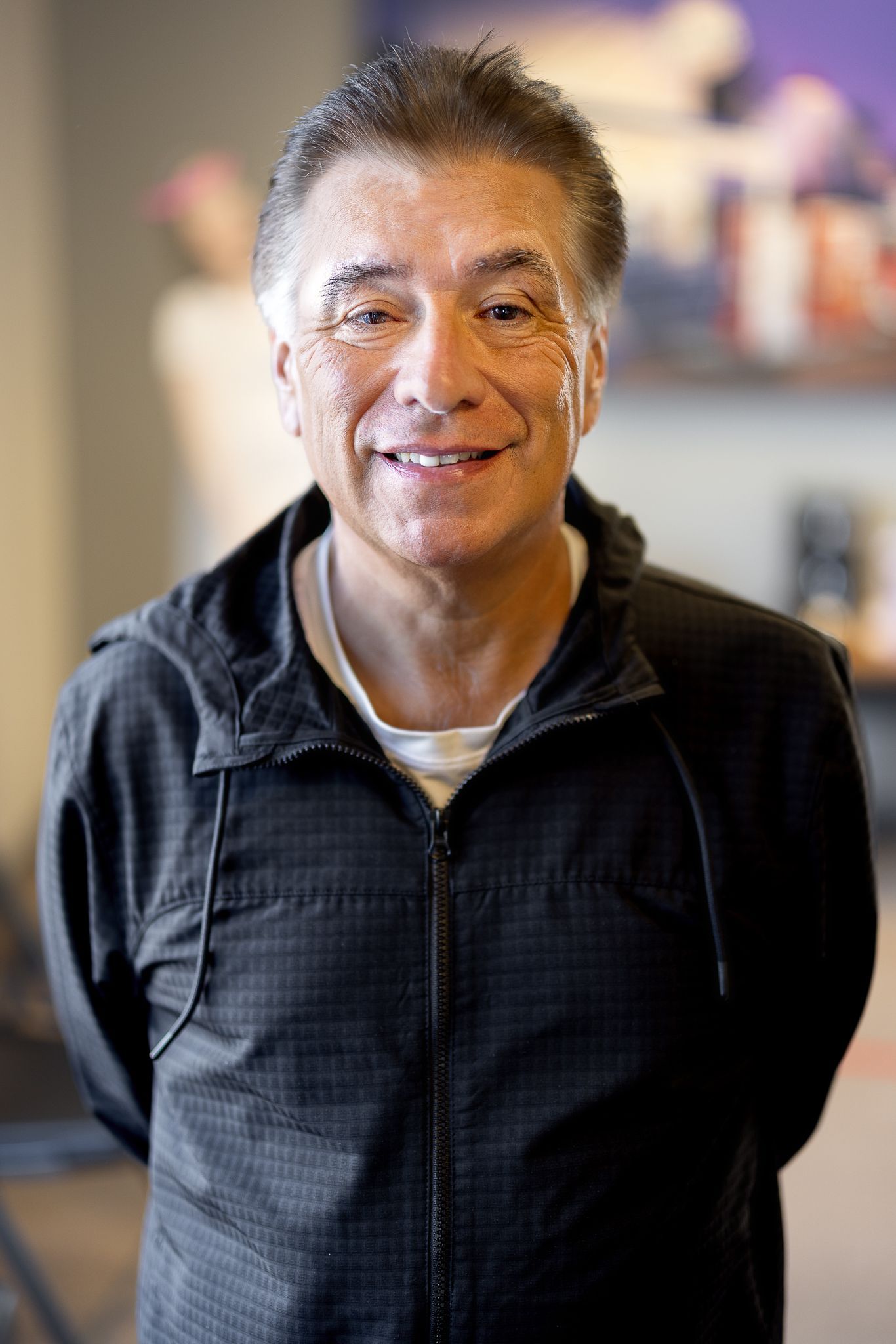 A man in a suit and tie is smiling for the camera.