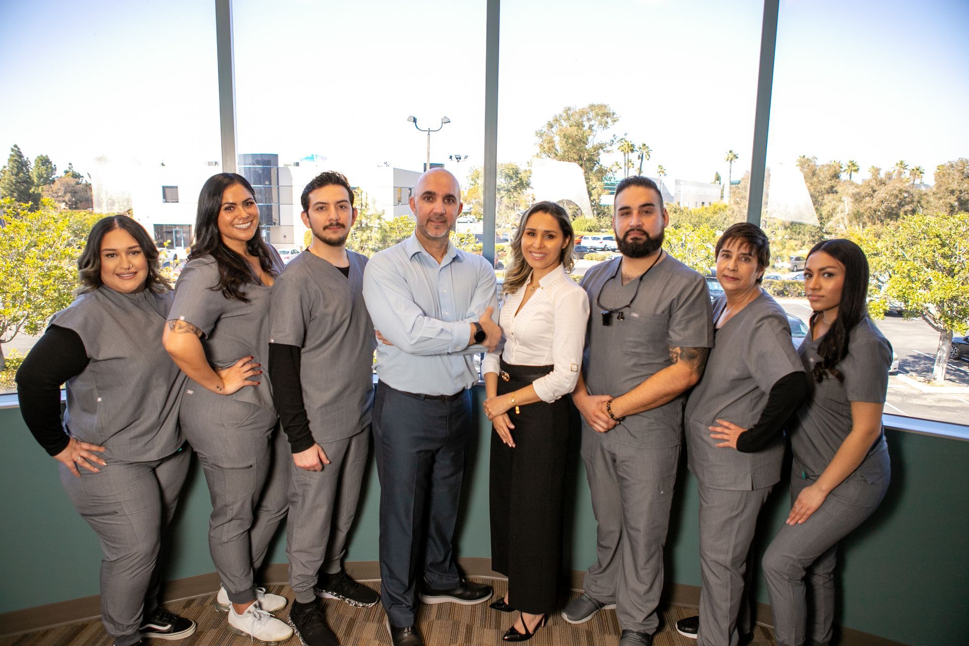A group of people are posing for a picture in a hallway.