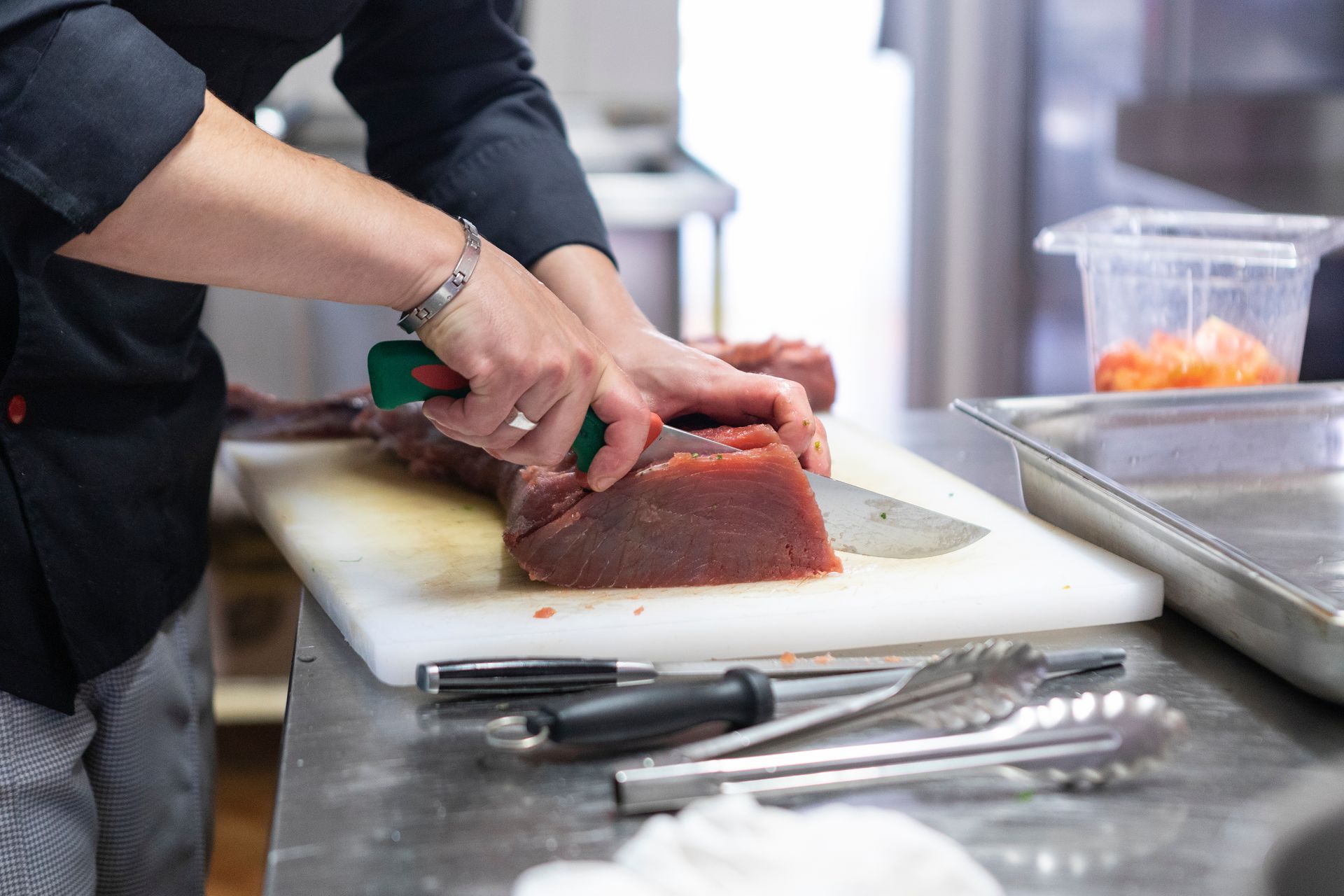 A man and a woman are sitting on a couch while a doctor writes on a clipboard.
