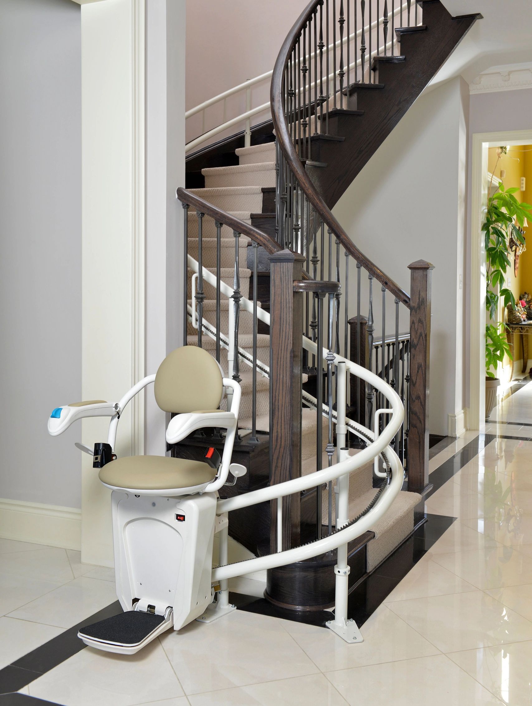 A stair lift is in front of a spiral staircase