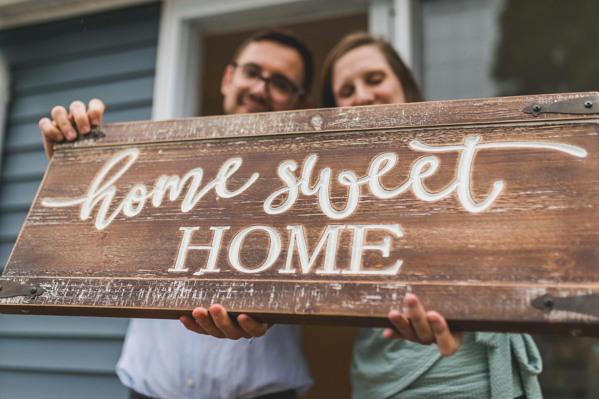 Couple holding a rustic wooden