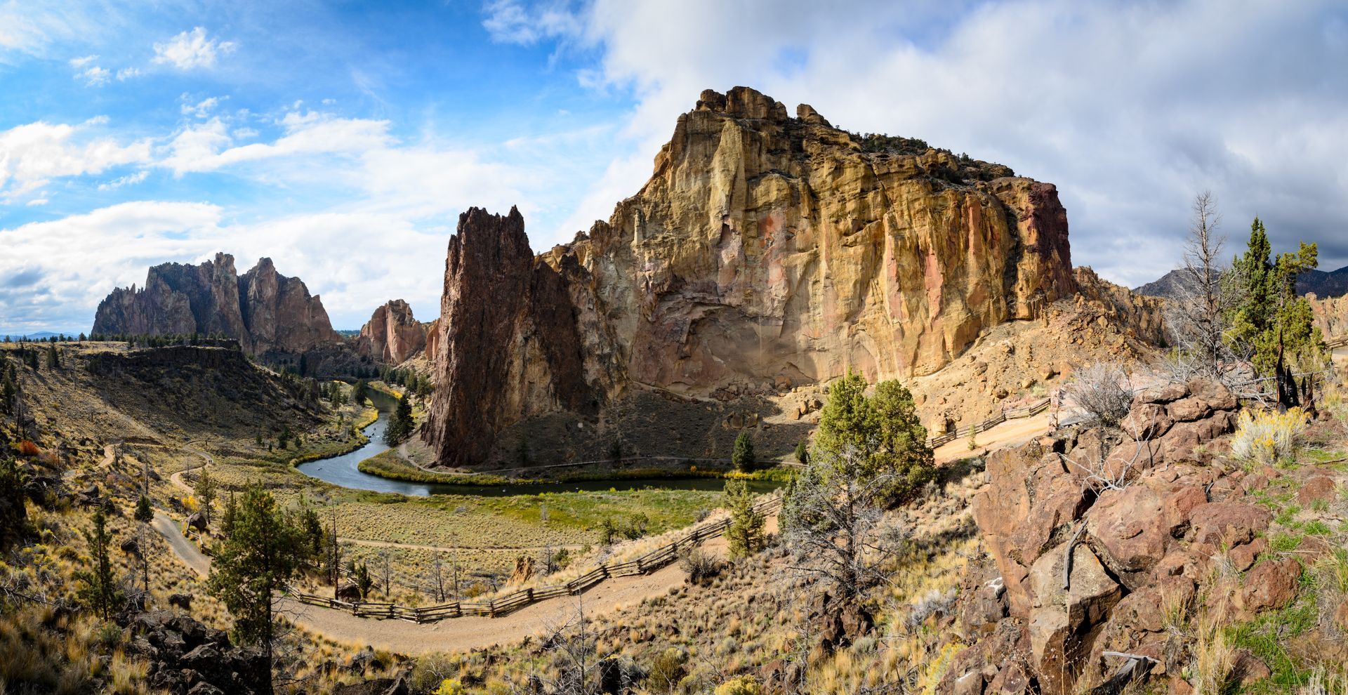 a river runs through a canyon surrounded by rocks and trees .