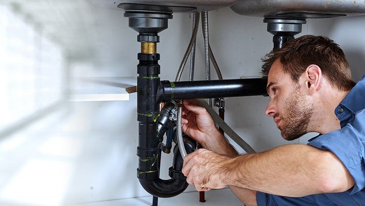 Plumber fixing sink