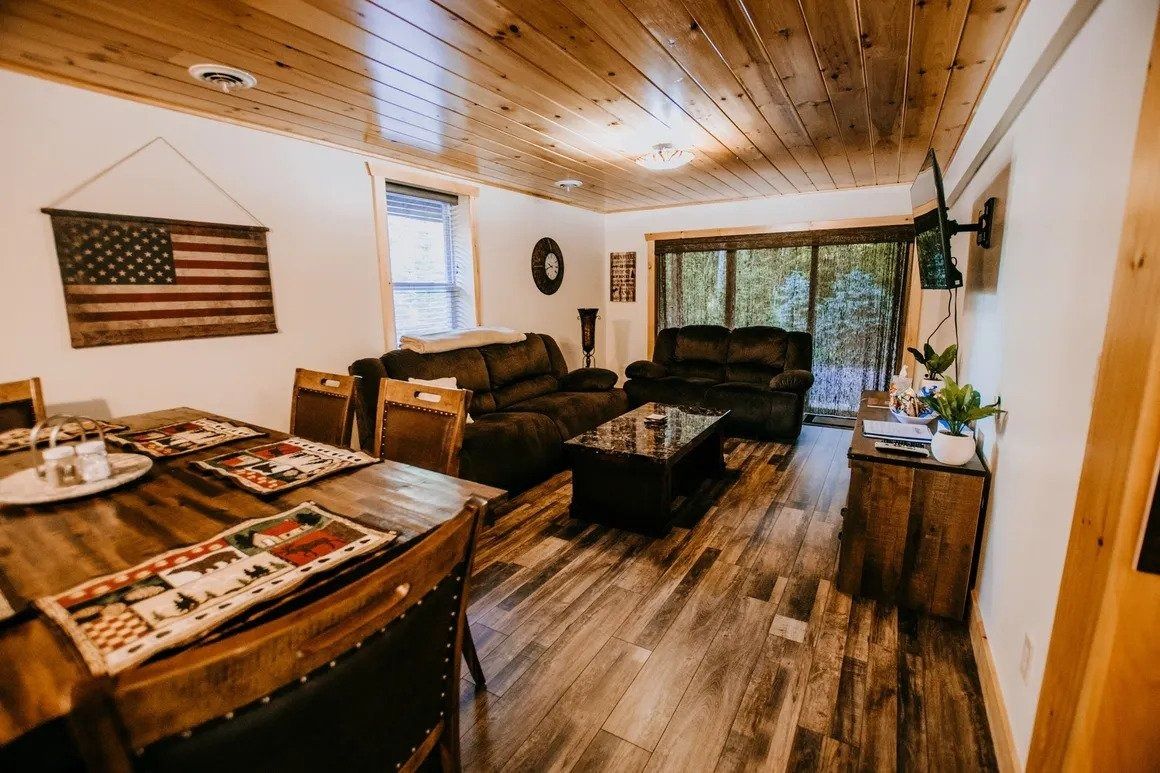 A living room with a couch , table and chairs.