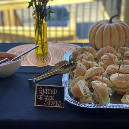 A tray of grilled chicken sliders on a table