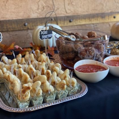 A table with a tray of food and bowls of sauce