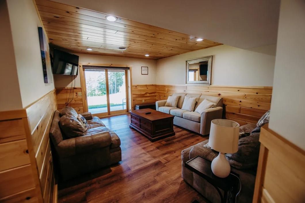 A living room filled with furniture and a sliding glass door.