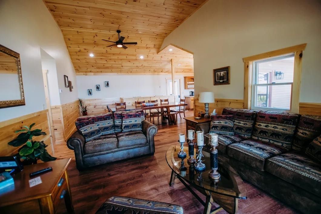 A living room filled with furniture and a ceiling fan.