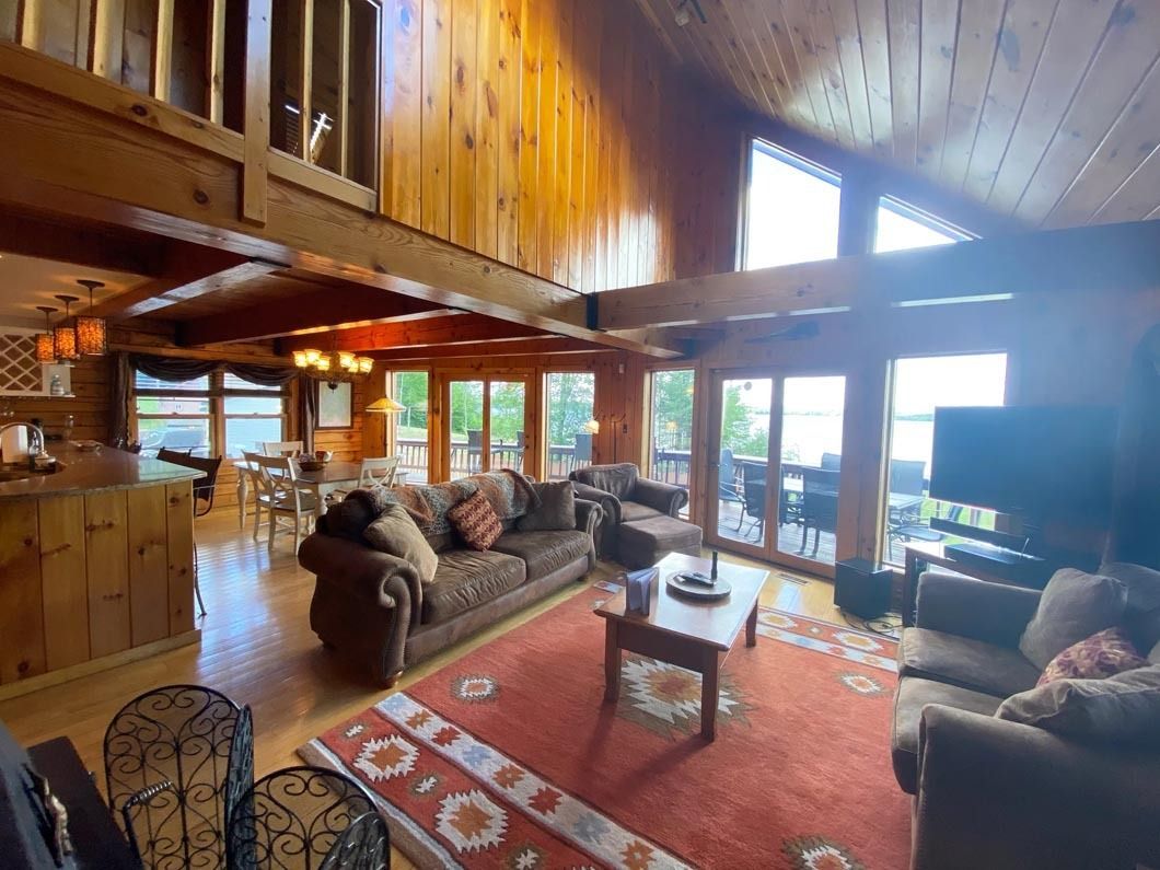 A living room filled with furniture and a lot of windows.