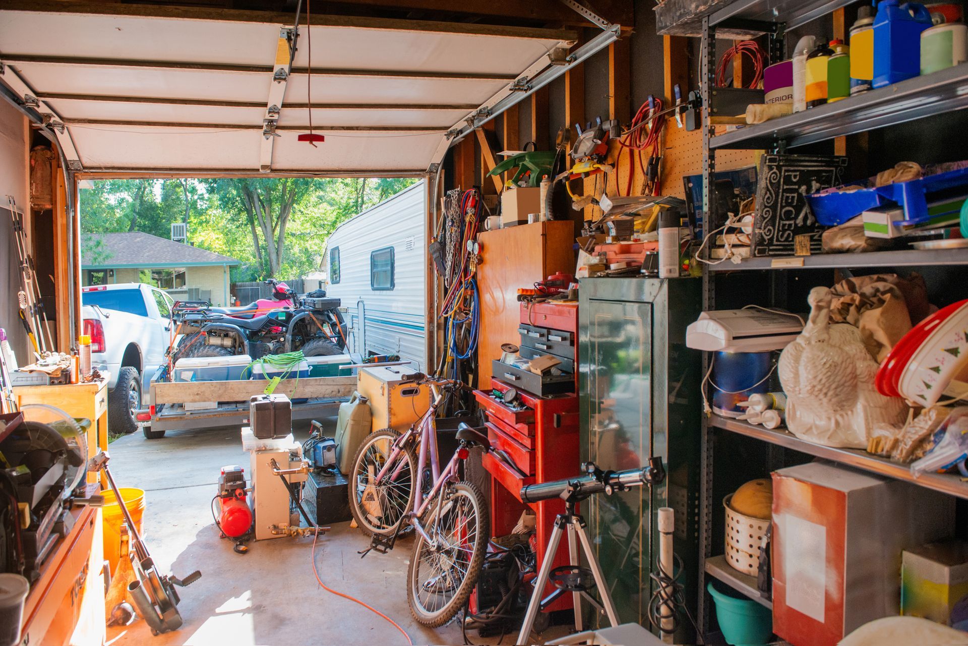 A garage filled with lots of tools and a bicycle.