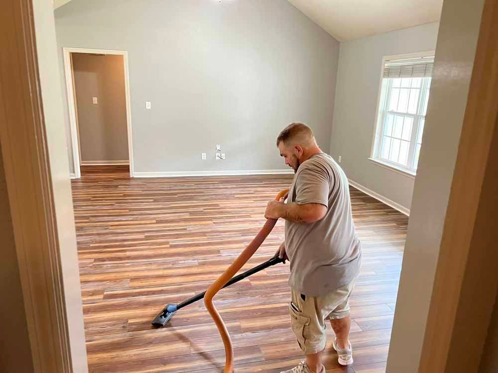 Vacuuming Floor in Living Room With Vacuum Cleaner