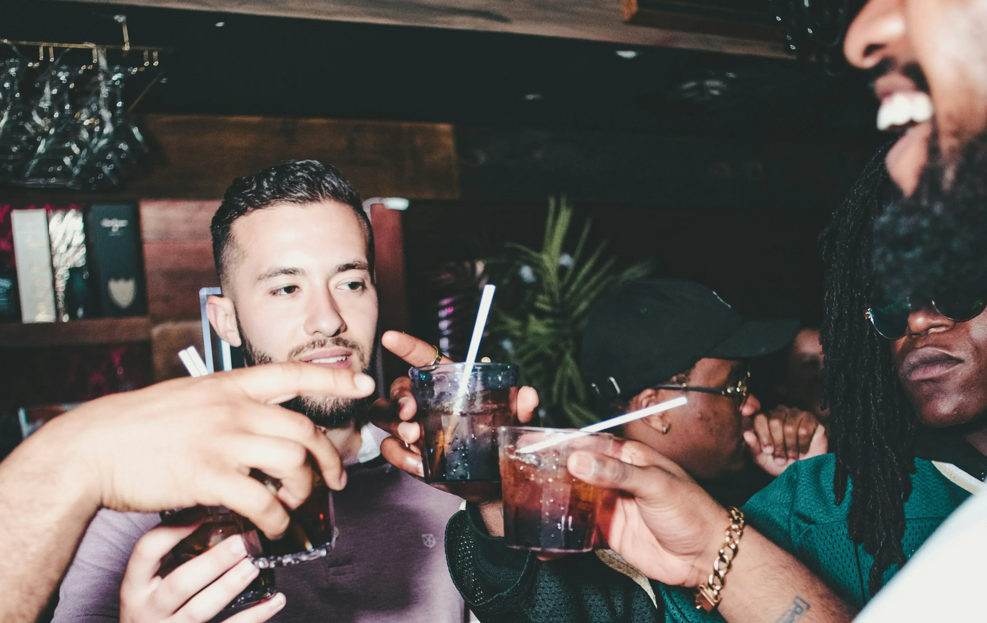 People toasting drinks in a bar. Cheers with cocktails.