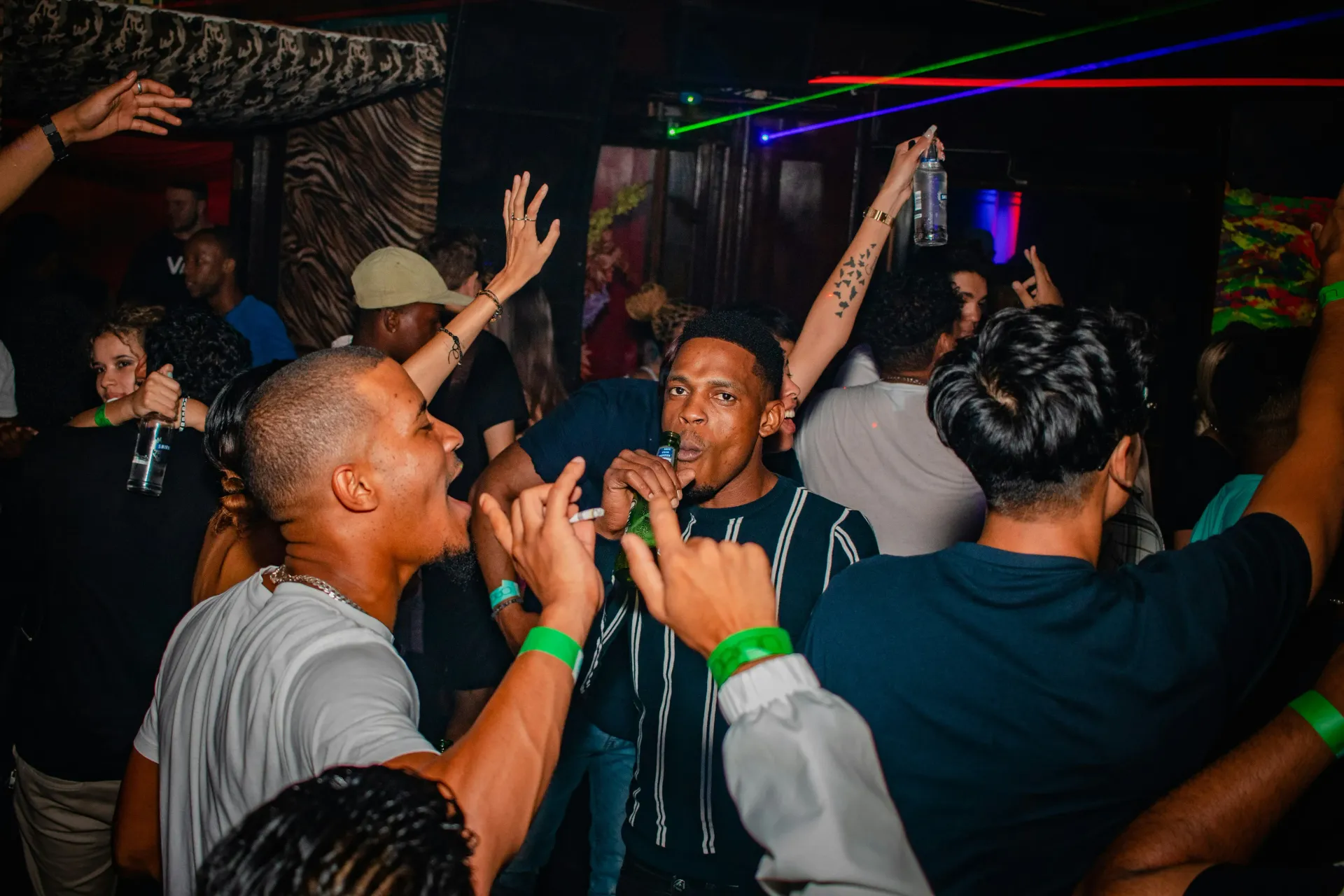 Group of men celebrating a night out with alcoholic drinks.