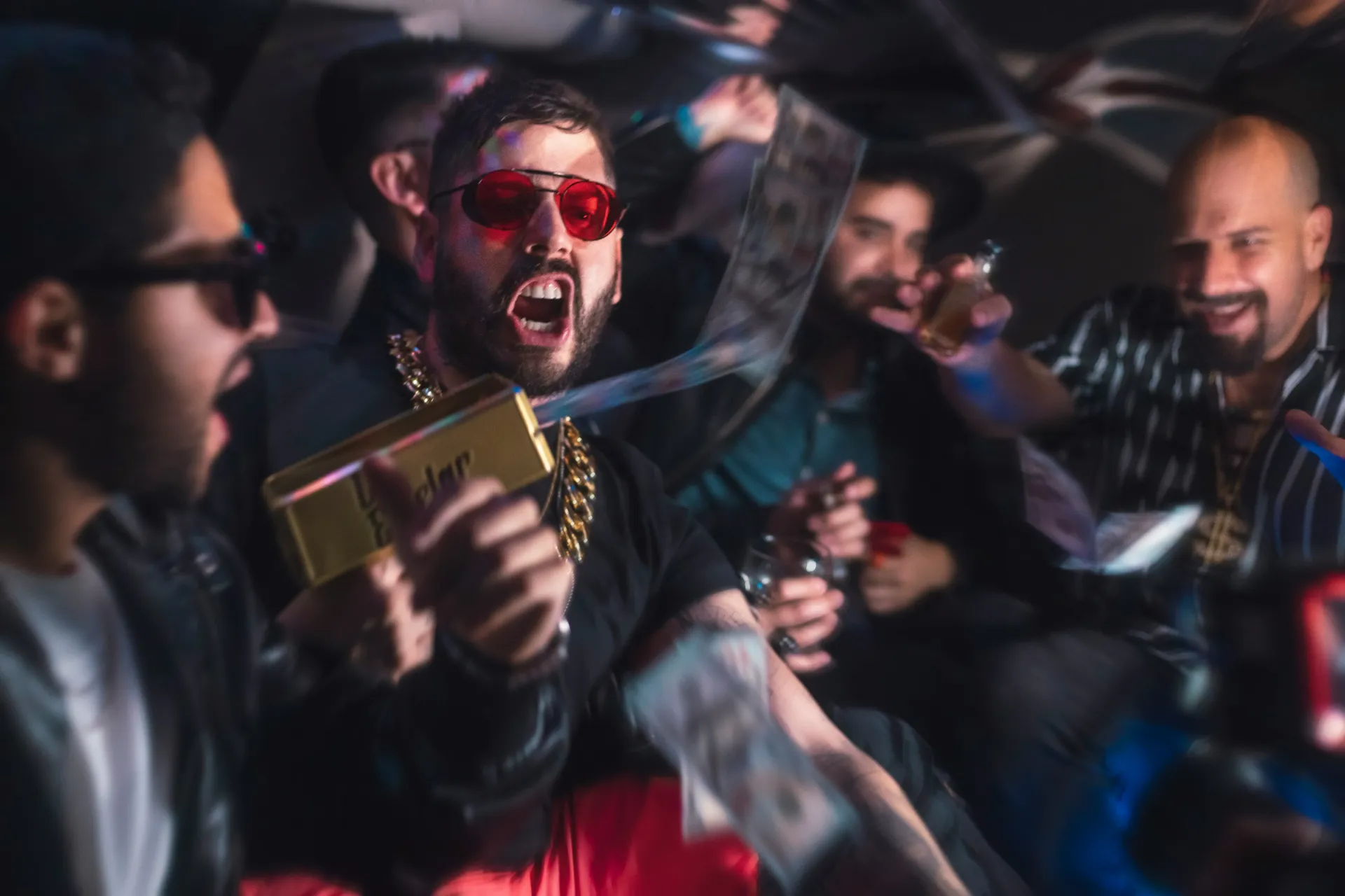 Group of men enjoying a bucks party shooting out money.