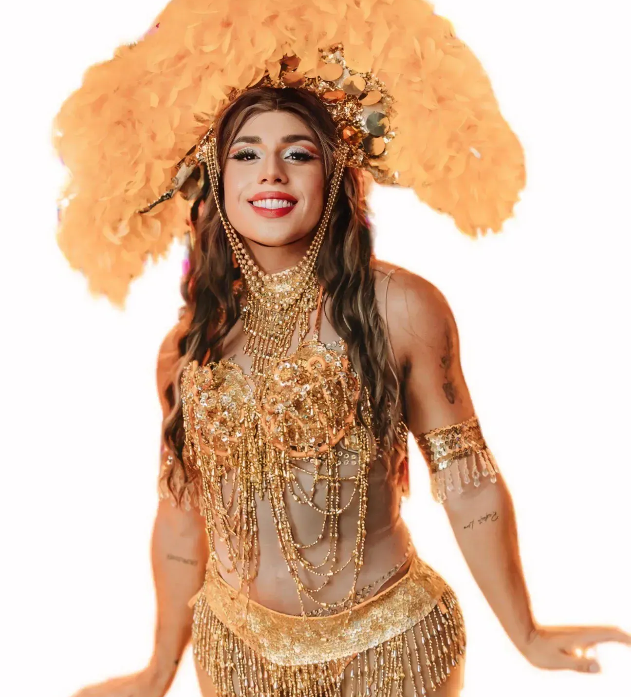 A drag performer dressed in a striking gold costume, showcasing her vibrant attire.
